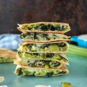 Tall stack of avocado and veggie quesadillas.