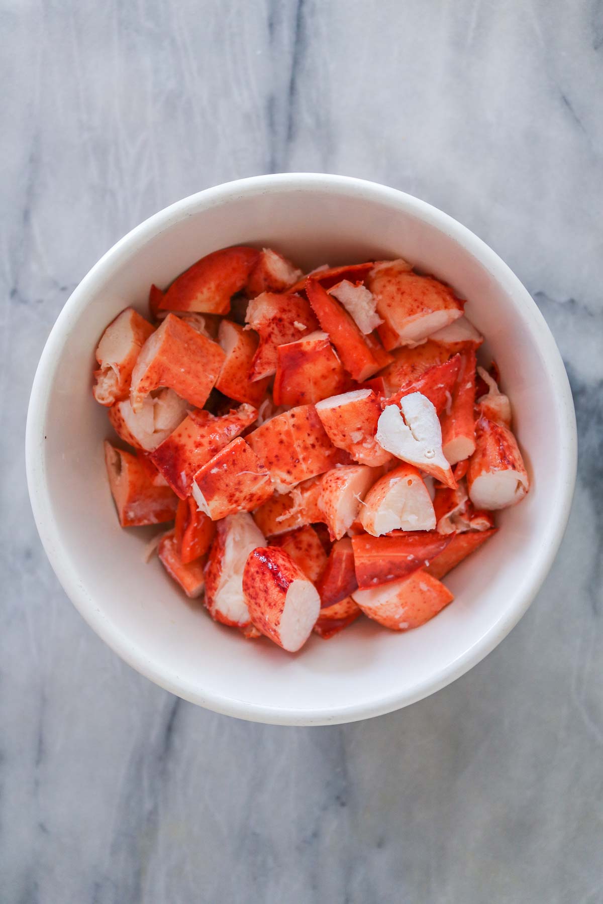 Chunks of cooked lobster meat in a bowl.