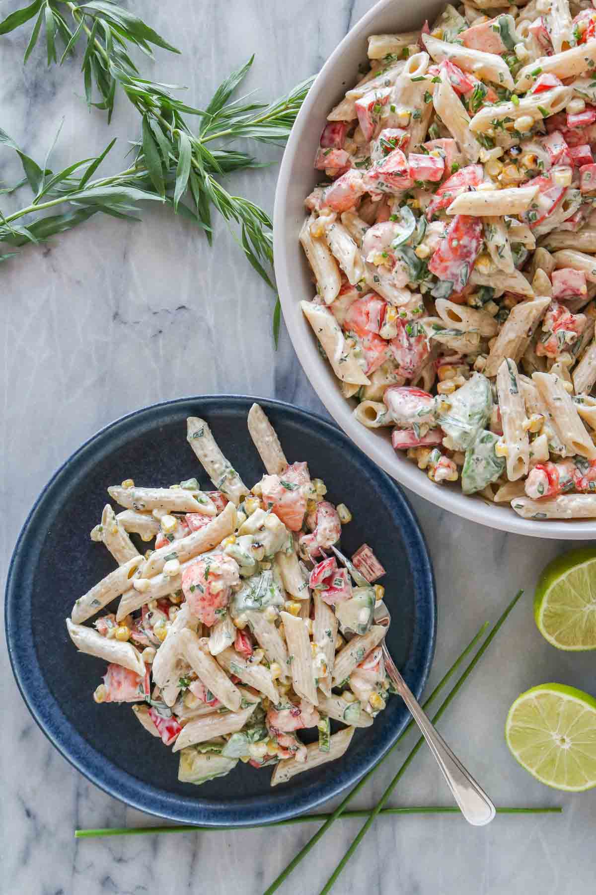 Lobster pasta salad, some on a plate and some in a serving bowl.