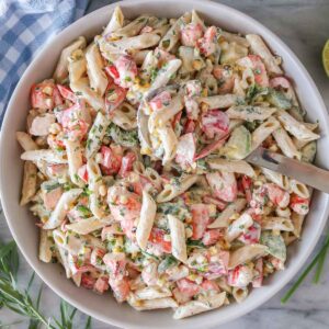 Lobster pasta salad in a serving bowl with a spoon.