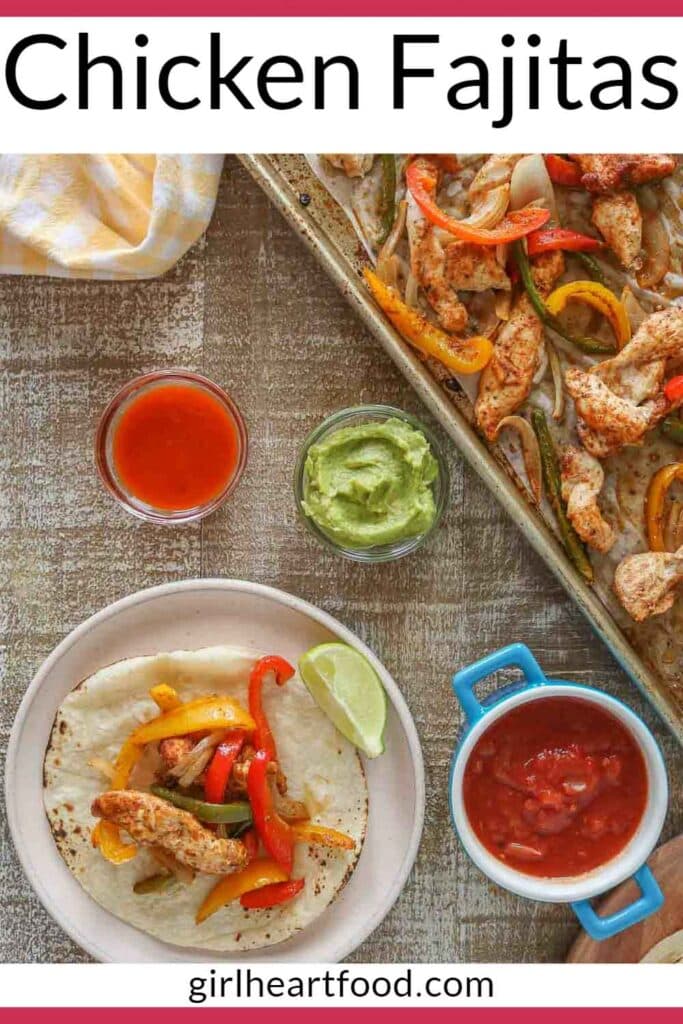 Chicken fajita on a plate next to toppings and a sheet pan with some of the chicken fajita mixture.