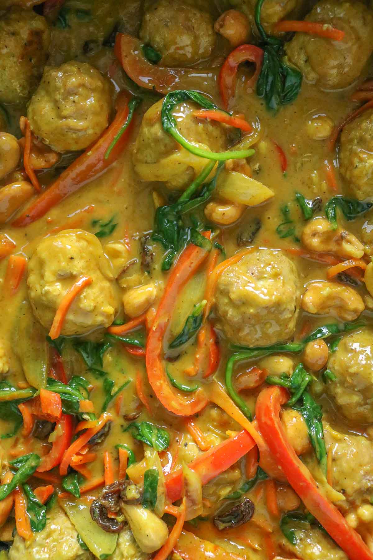 Close-up of turkey meatballs in curry sauce.