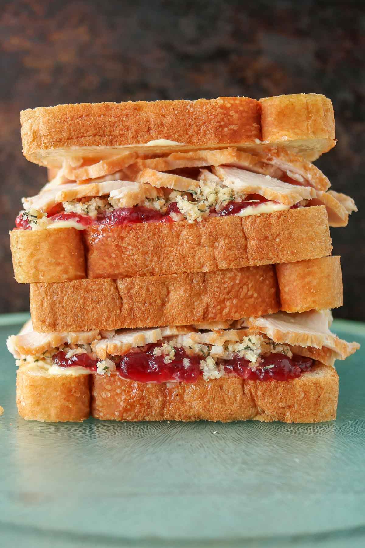 Stack of two turkey and dressing sandwiches.