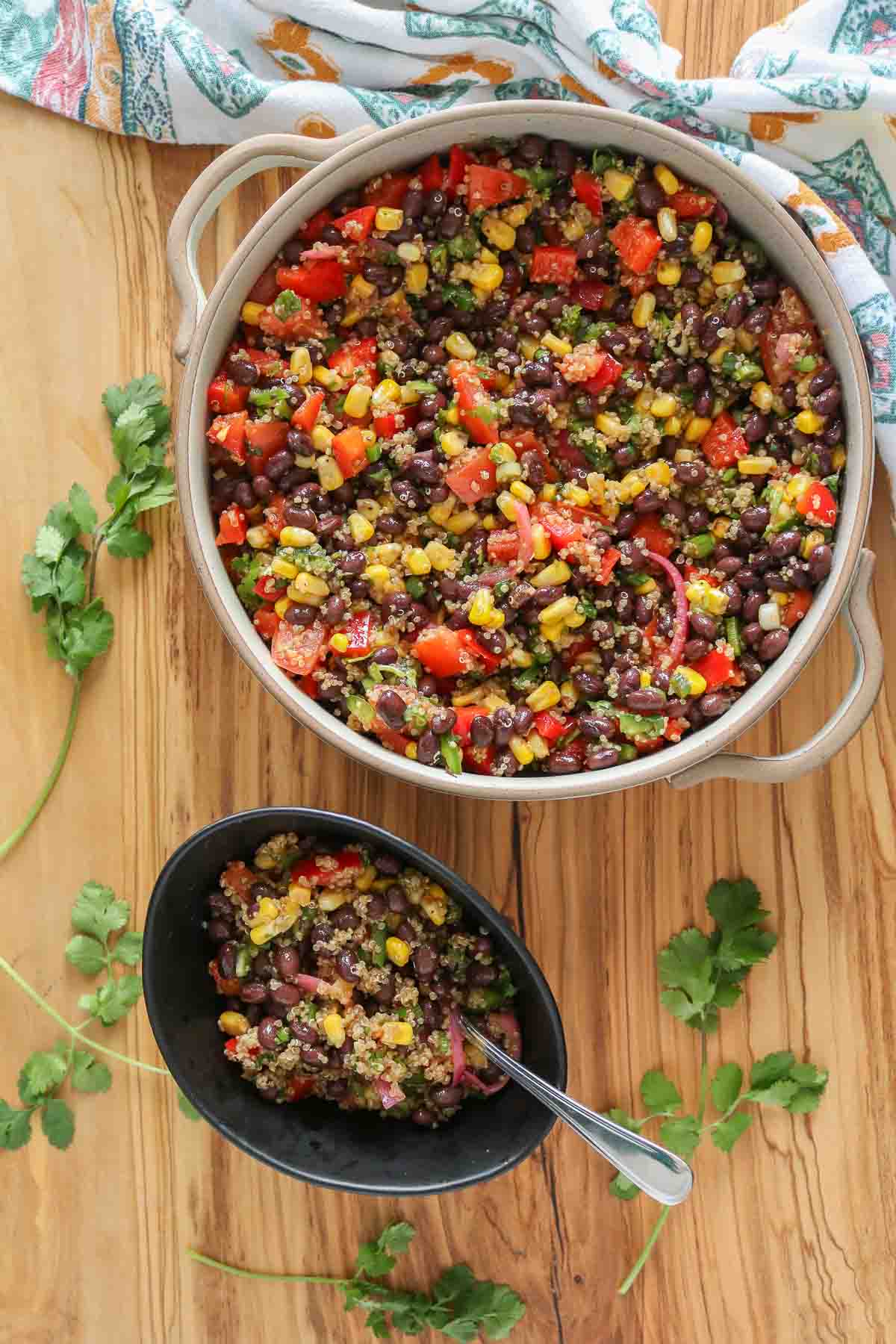Corn and black bean quinoa salad, some in a serving dish and some in a small bowl.
