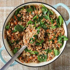 Ground chicken and rice skillet with a serving spoon.