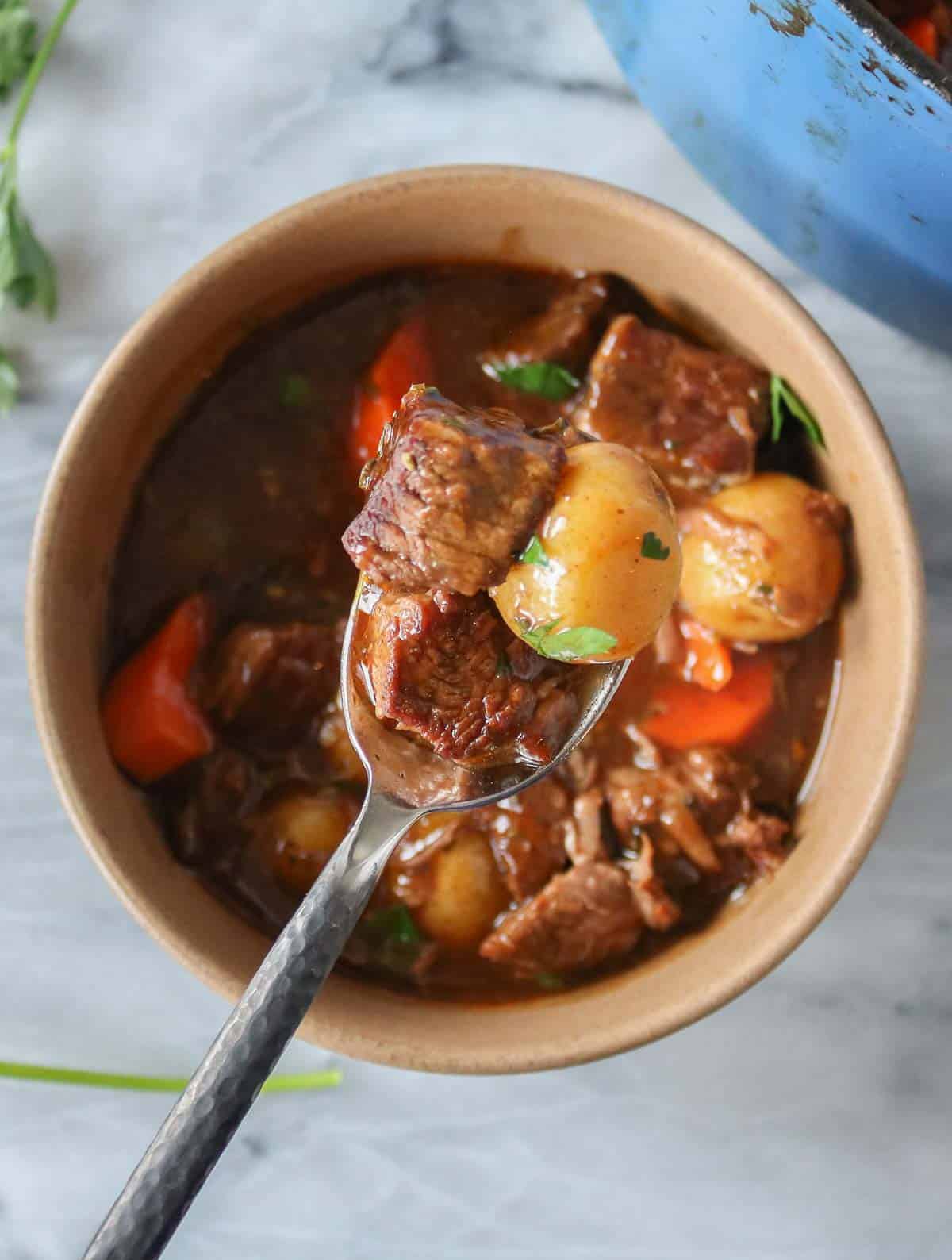 Spoonful of beef stew from a bowl.