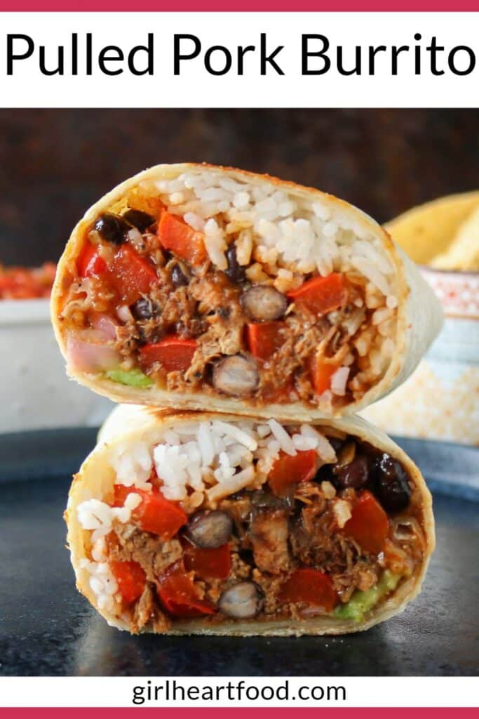 Two pulled pork burritos stacked on a dark blue plate.
