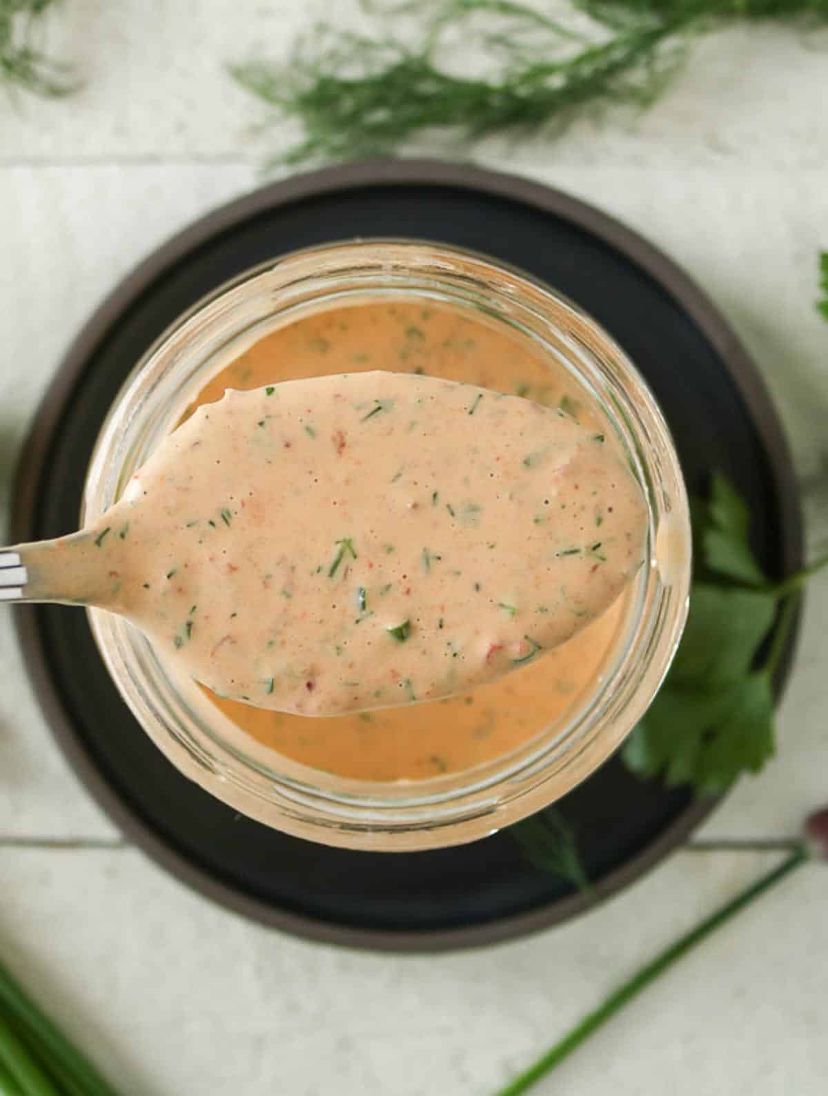 Spoonful of chipotle ranch dressing from a jar.