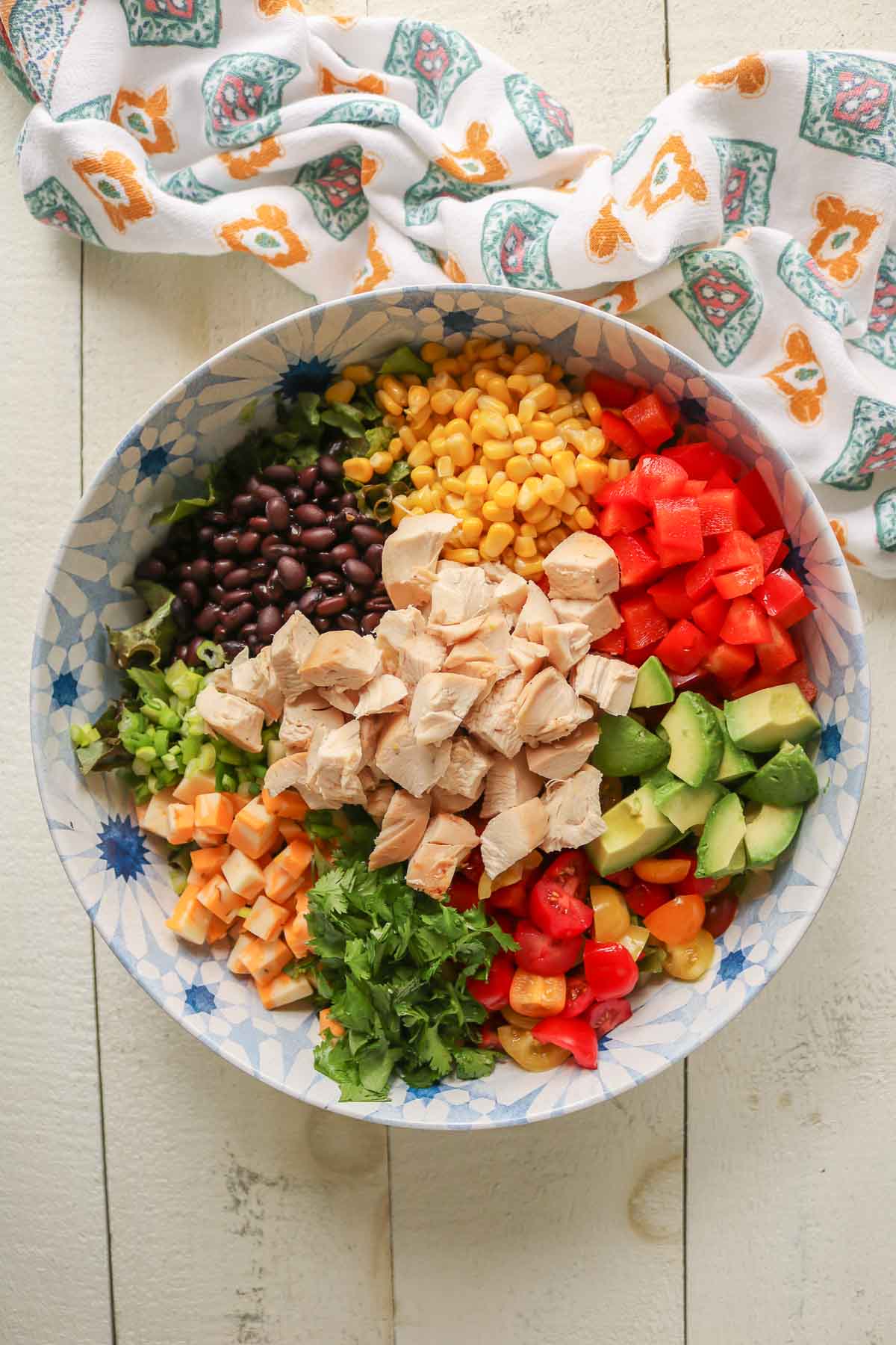 Southwest chicken salad ingredients in a serving bowl before being mixed together.
