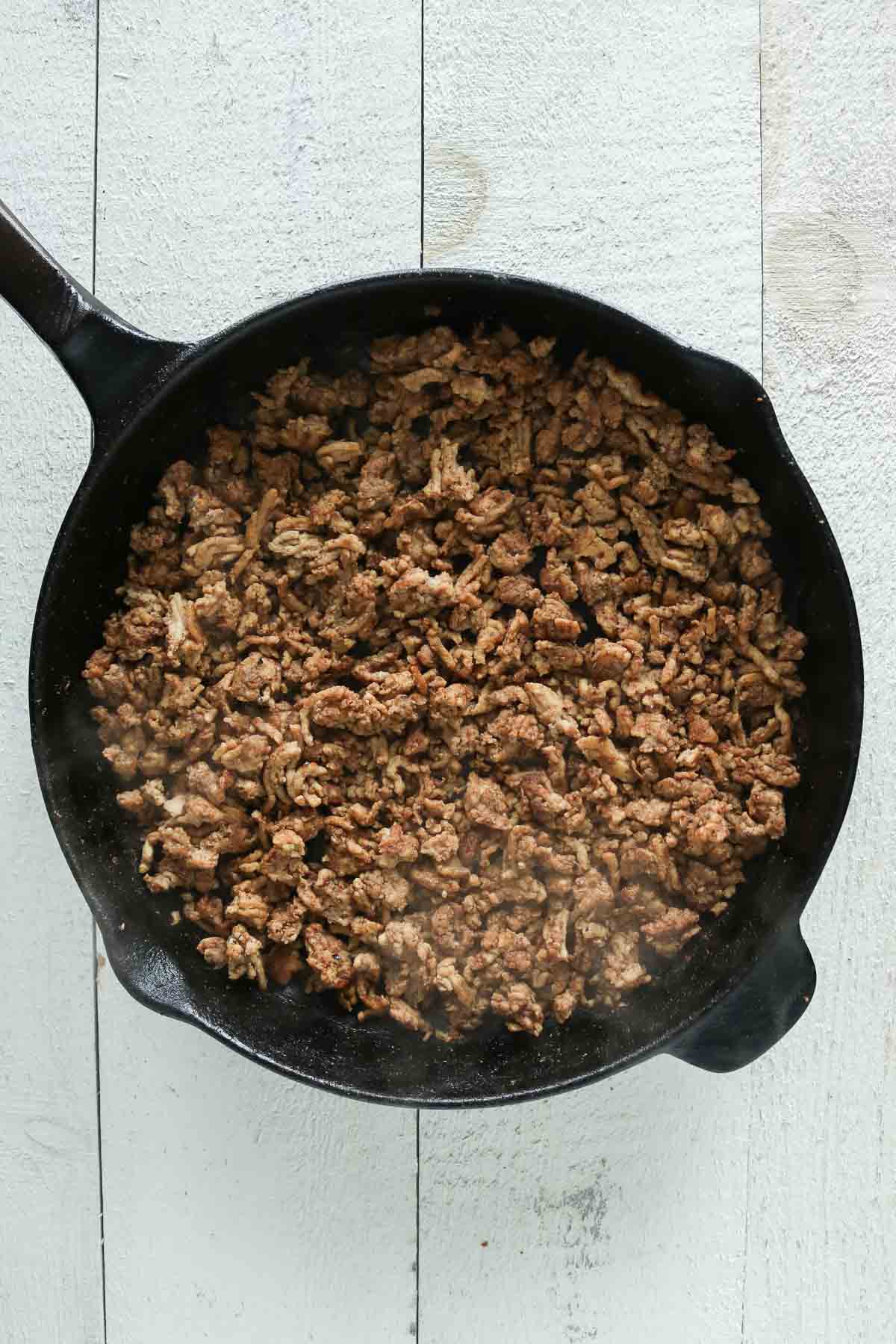 Cooked ground chicken in a skillet.