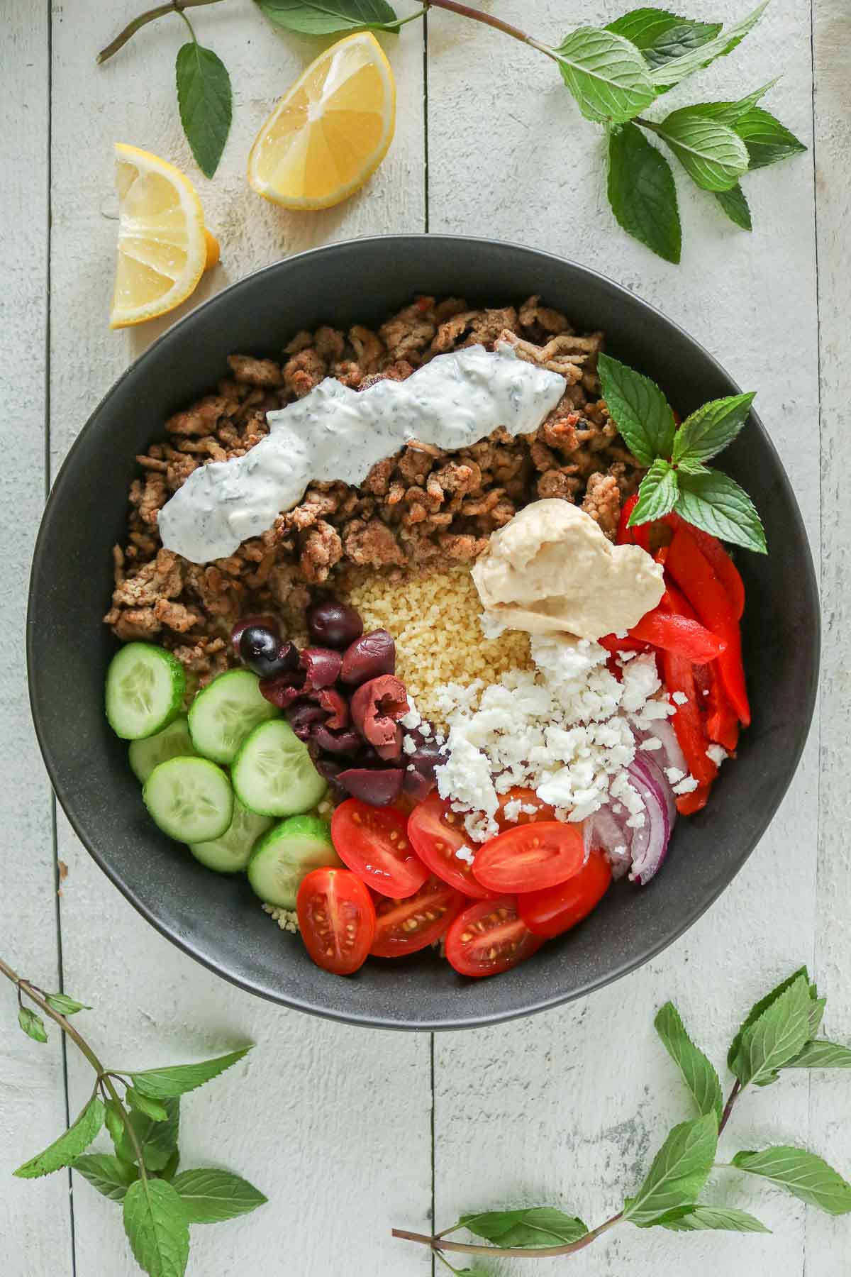Ground chicken and couscous bowl with toppings.