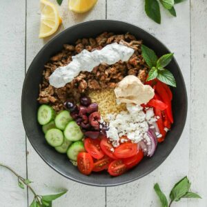 Ground chicken and couscous bowl with toppings.