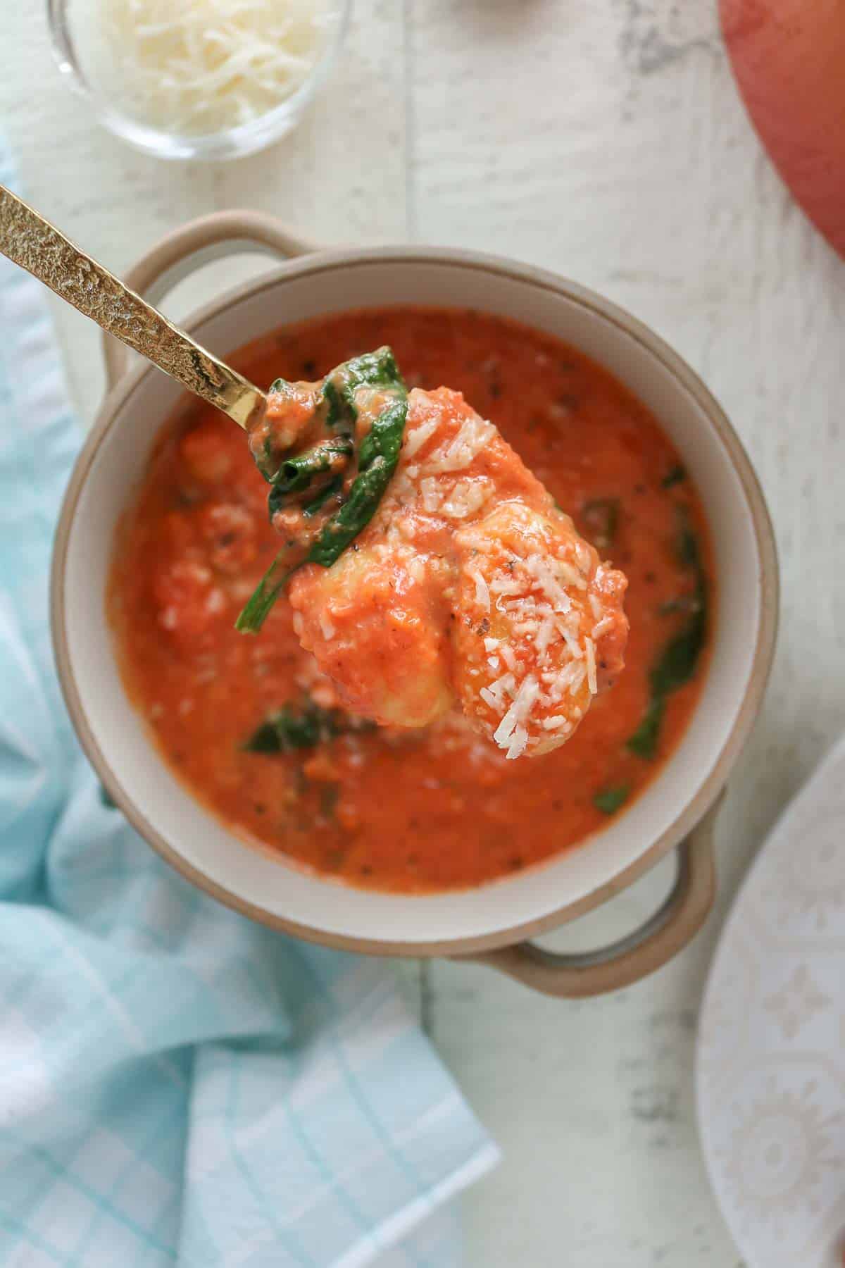Spoonful of gnocchi tomato soup from a bowl.