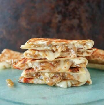 Stack of four caramelized onion quesadillas.