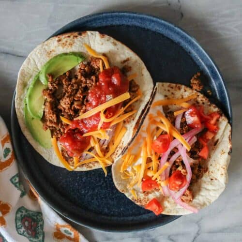 Two ground chicken tacos on a plate.