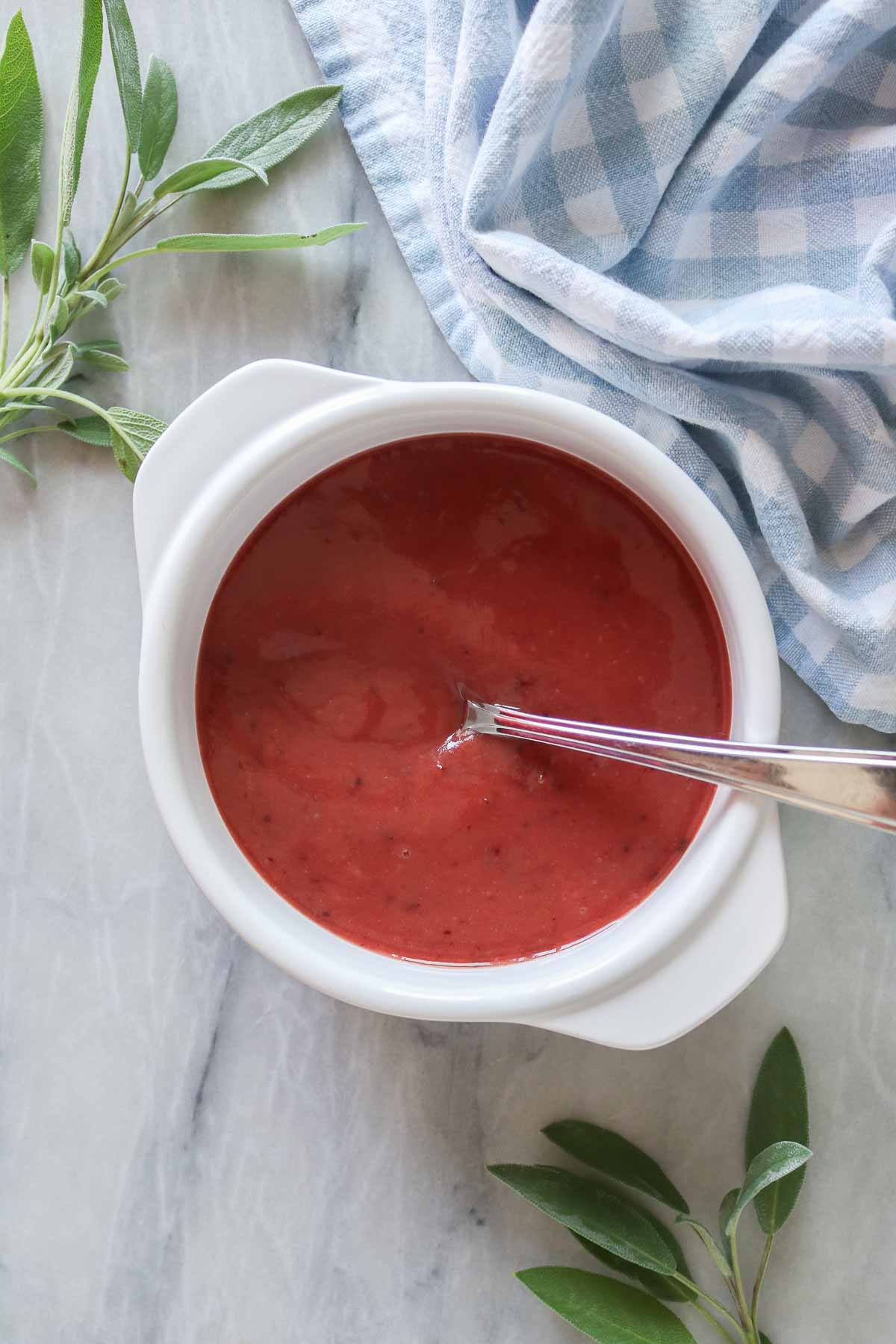 Cranberry mustard sauce in a serving dish with a spoon.
