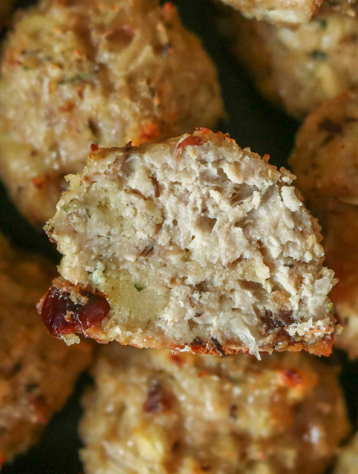 Close-up of the interior of a stuffing chicken meatball, showing how juicy it is.