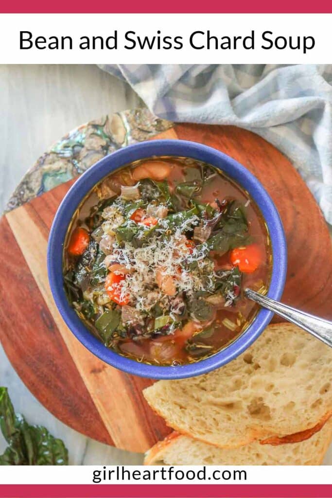 Bowl of bean and Swiss chard soup garnished with grated Parmesan cheese.