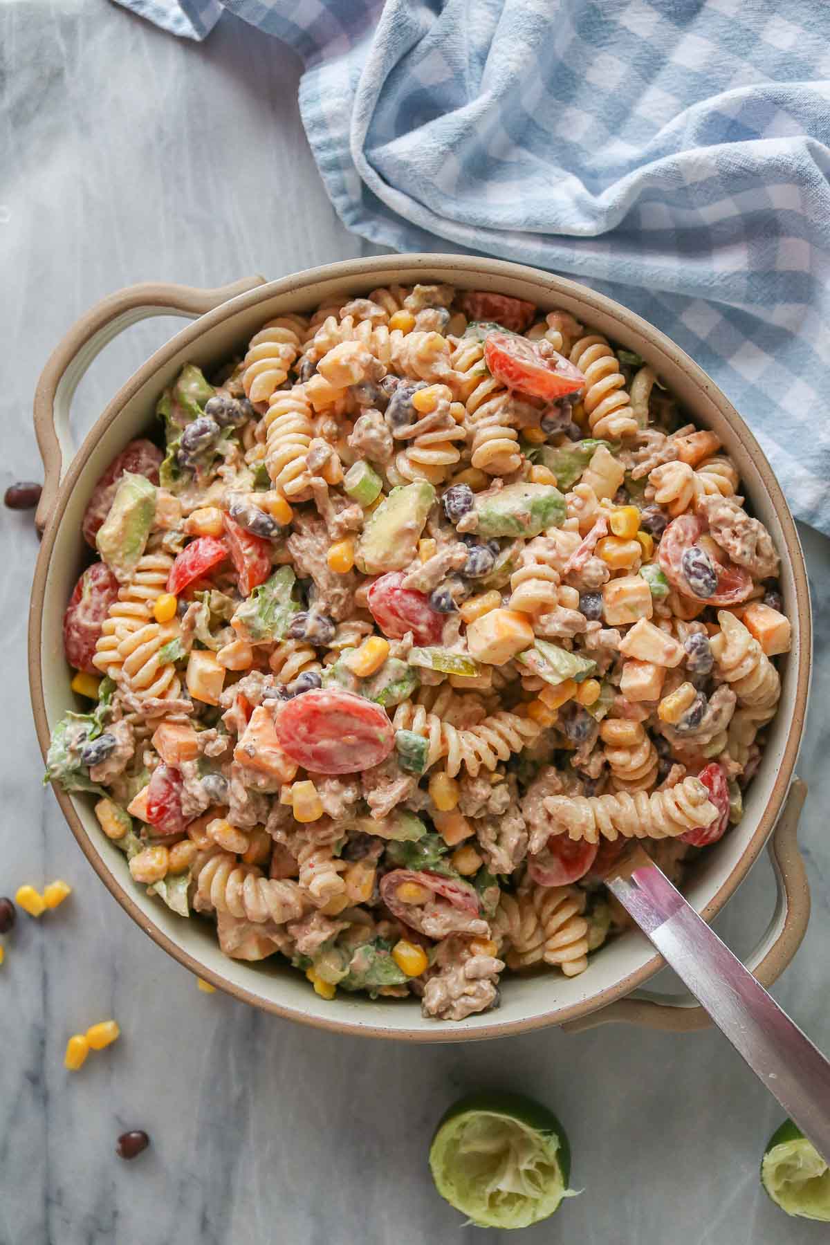 Taco pasta salad in a serving bowl with a serving spoon.
