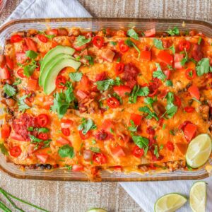 Turkey taco casserole garnished with toppings.