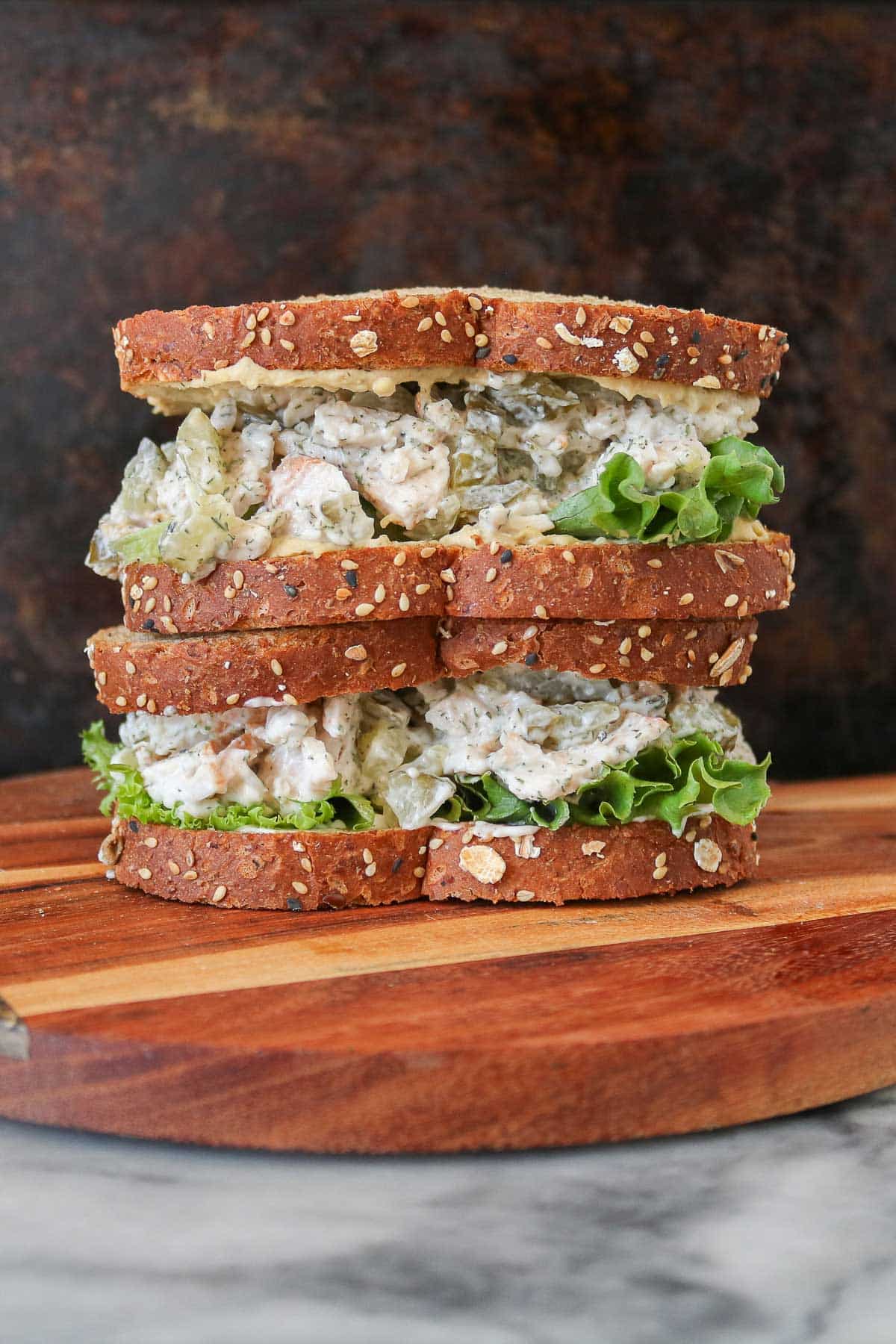 Stack of two dill pickle turkey salad sandwiches.