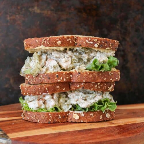 Stack of two dill pickle turkey salad sandwiches.
