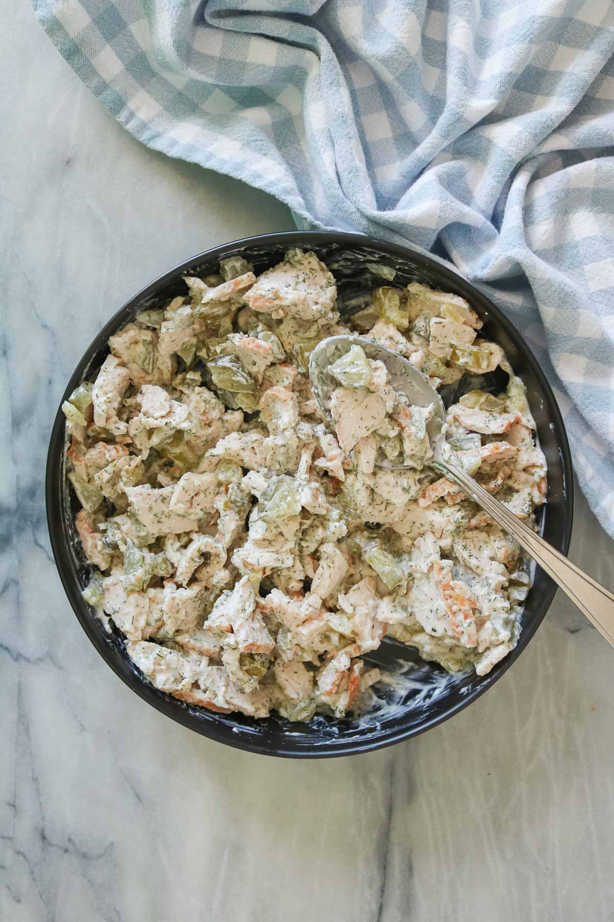 Dill pickle turkey salad in a bowl with a spoon.