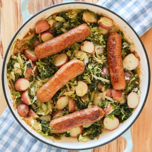Sauté pan with four sausage, cabbage and potatoes.